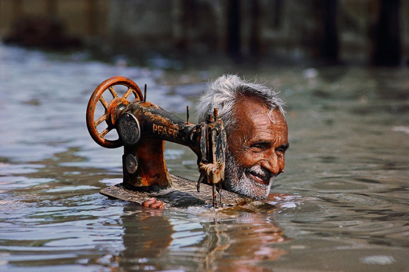 INDE-homme-transporte-machine-a-coudre-fleuve-photo-steve-McCurry